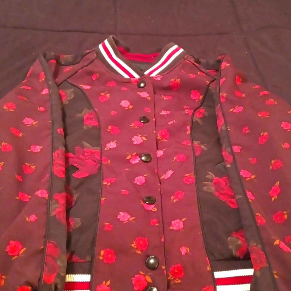Reversible coach limited edition jacket with red roses on one side.